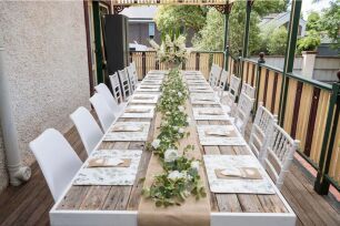 Rustic tables and chairs for a home wedding reception