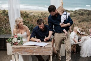 Signing the registry at a beachside wedding ceremony